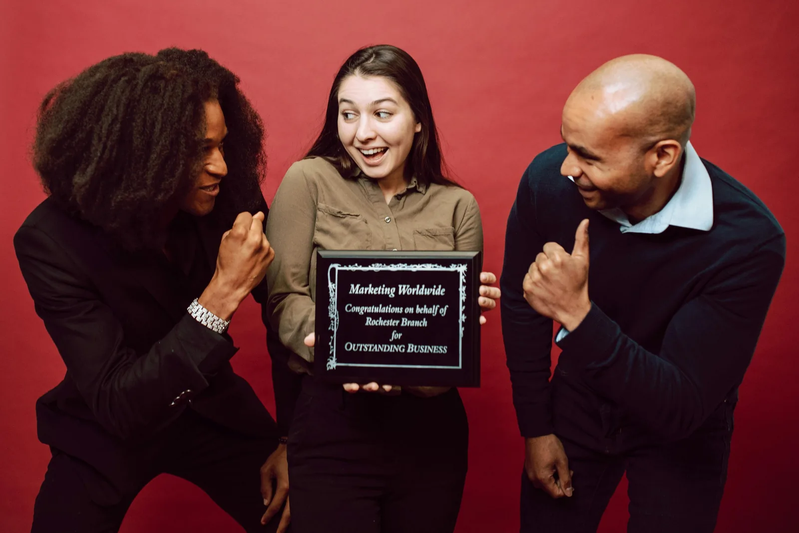 picture of three people holding a random award plaque